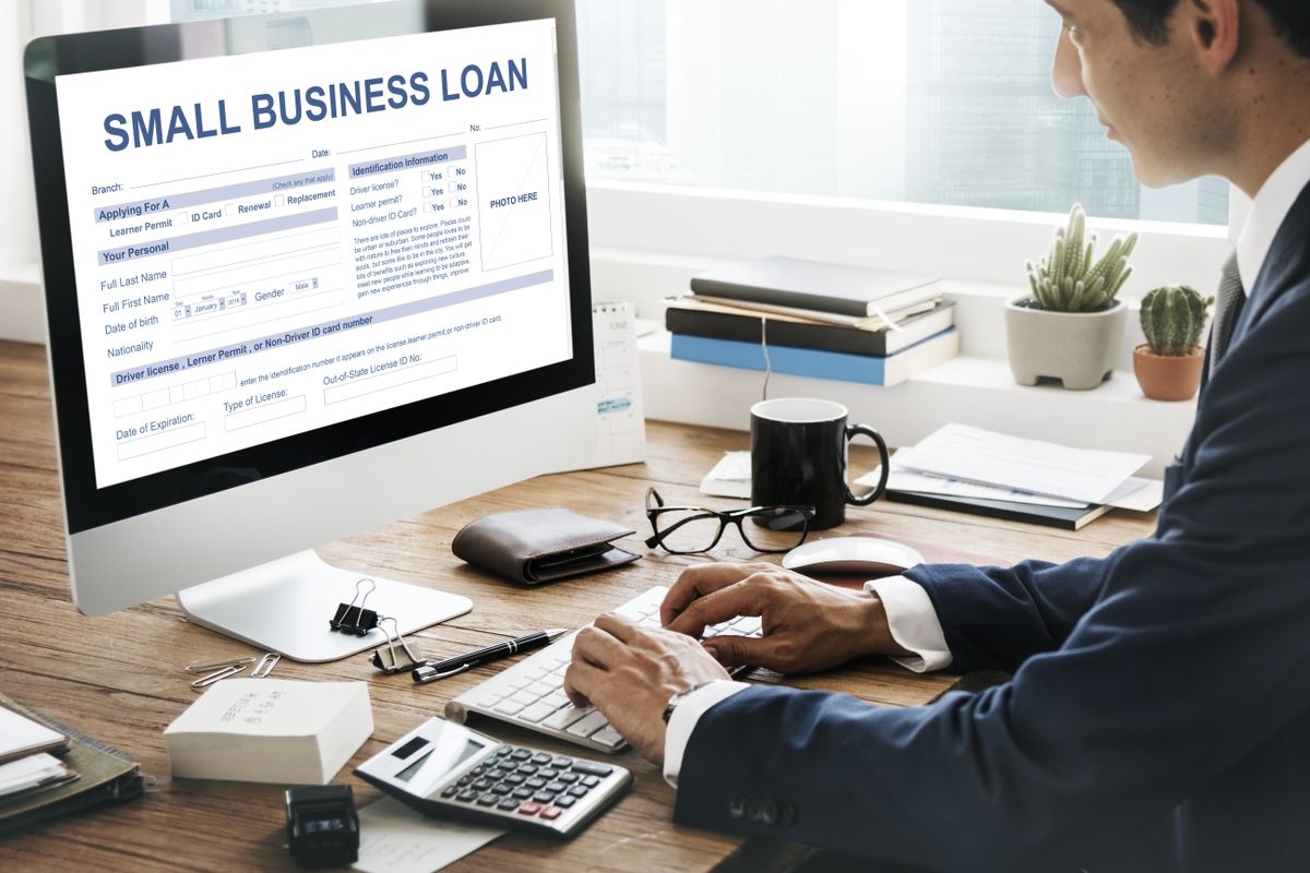 A business owner working through a small business loan on a desktop computer